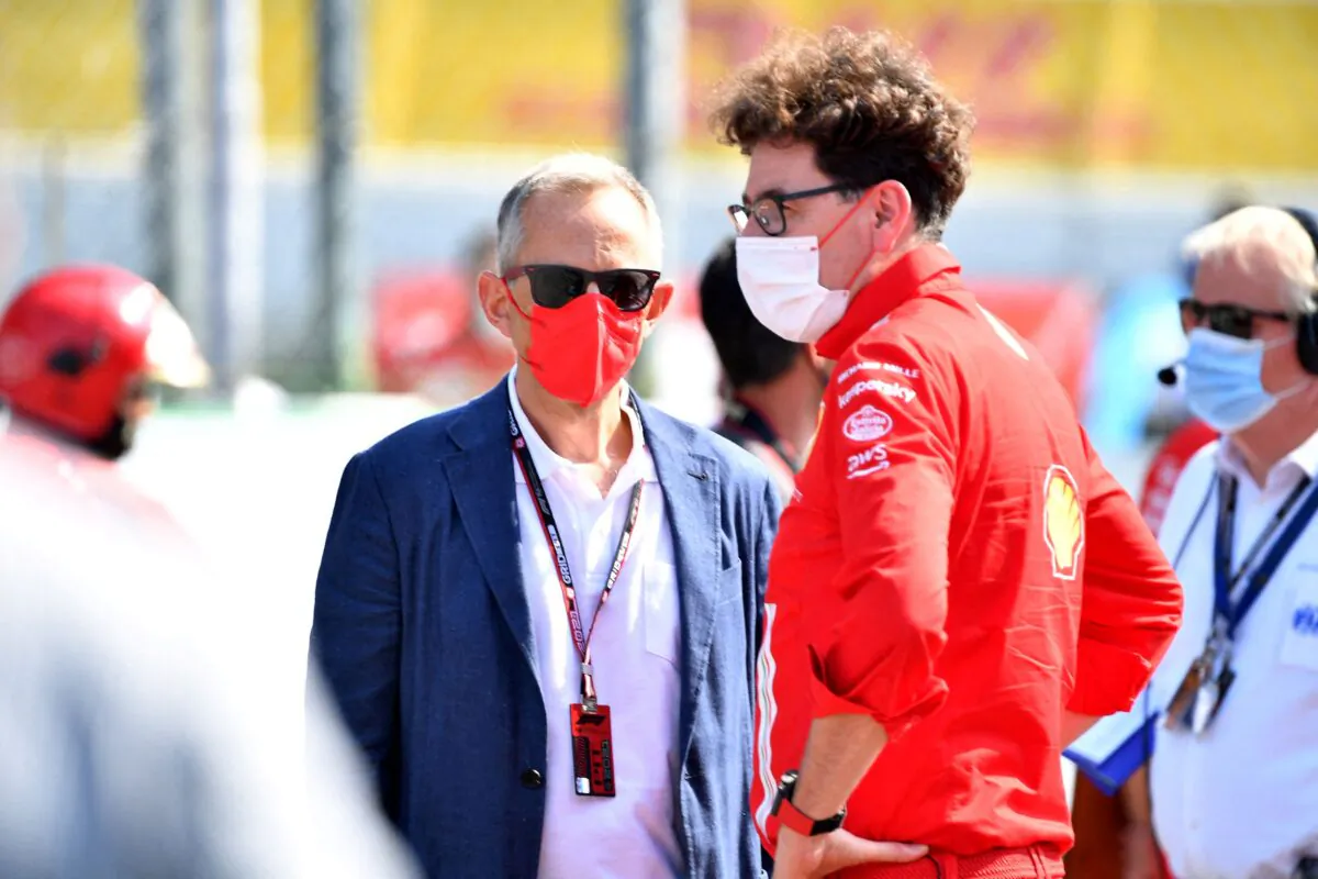 Ferrari CEO Benedetto Vigna and team principal Mattia Binotto are seen in protective face masks on the grid before the race in Monza, Italy, on Sept. 12, 2021. (Jennifer Lorenzini/Reuters)
