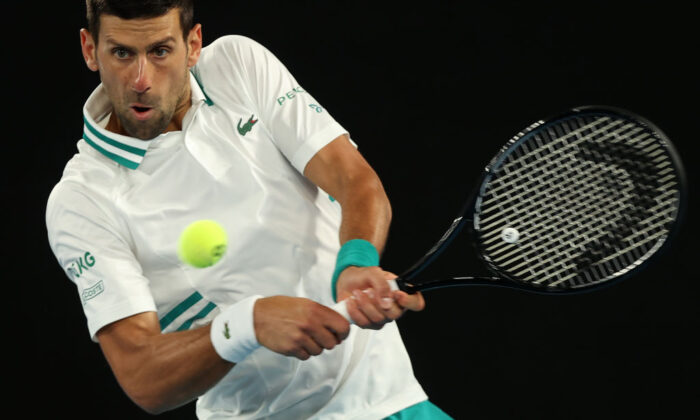Serbia's Novak Djokovic hits a return against Canada's Milos Raonic during their men's singles match on day seven of the Australian Open tennis tournament in Melbourne, Australia, on Feb. 14, 2021. (Brandon Malone/AFP via Getty Images)