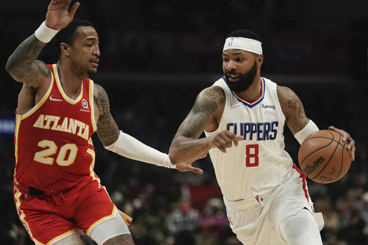 Los Angeles Clippers' Marcus Morris Sr., right, drives past Atlanta Hawks' John Collins during second half of an NBA basketball game in Los Angeles on Jan. 9, 2022. (AP Photo/Jae C. Hong)