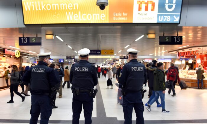 Policemen and passengers are seen in the main train station of Duesseldorf, western Germany, on March 10, 2017. (Horst Ossinger/AFP via Getty Images)