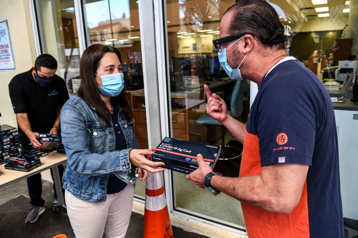 Employees of the Miami-Dade Public Library System distribute COVID-19 home rapid test kits in Miami, Fla., on Jan. 8, 2022. (Chandan Khanna/AFP via Getty Images)