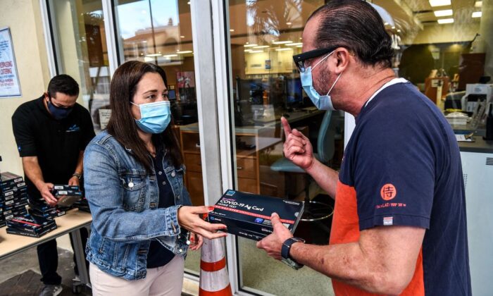 Employees of the Miami-Dade Public Library System distribute COVID-19 home rapid test kits in Miami, Fla., on Jan. 8, 2022. (Chandan Khanna/AFP via Getty Images)