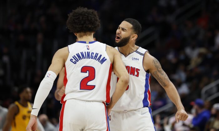 Detroit Pistons guard Cade Cunningham (2) receives congratulations from guard Cory Joseph (18) after he makes a three point basket in the second half against the Utah Jazz at Little Caesars Arena in Detroit, on Jan. 10, 2022. (Rick Osentoski/USA TODAY Sports via Field Level Media)
