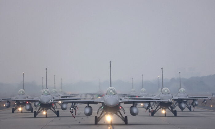 12 F-16V fighter jets perform an elephant walk during an annual New Year's drill in Chiayi, Taiwan, on Jan. 5, 2022. (Ann Wang/Reuters)