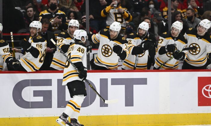 Boston Bruins defenseman Matt Grzelcyk (48) is congratulated by teammates, after scoring a goal against the Washington Capitals during an NHL game at Capital One Arena in Washington on Jan. 10, 2022. (Brad Mills/USA TODAY Sports via Field Level Media)