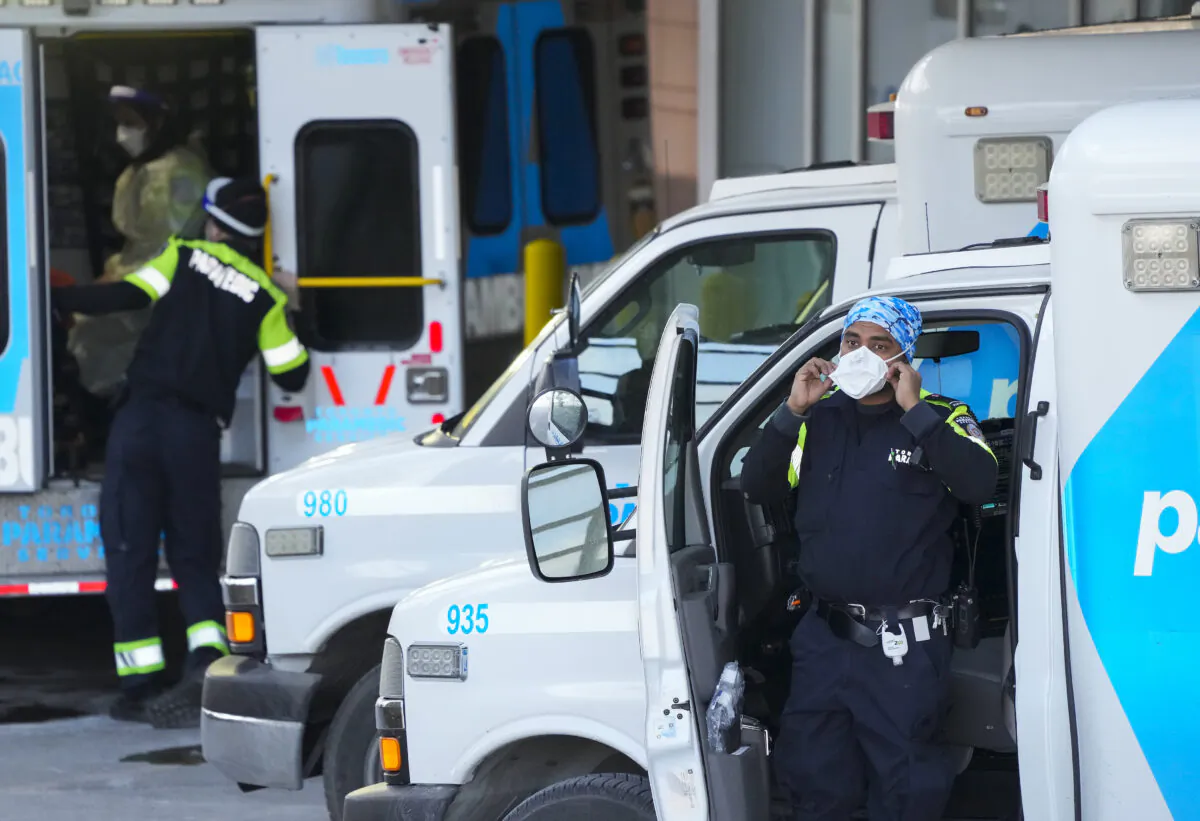 Paramedics transfer a patient from an ambulance to the emergency department at Michael Garron Hospital in Toronto on Jan. 10, 2022. (The Canadian Press/Nathan Denette)