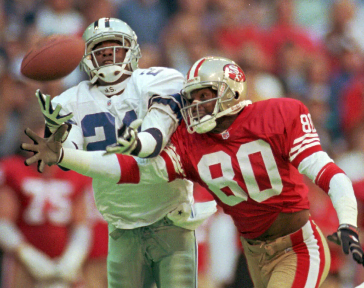 Dallas Cowboys defender Deion Sanders (21) knocks the ball away from San Francisco 49ers receiver Jerry Rice (80), during an NFL game in Irving, Texas, on Nov. 12, 1995. (Eric Gay/AP Photo)