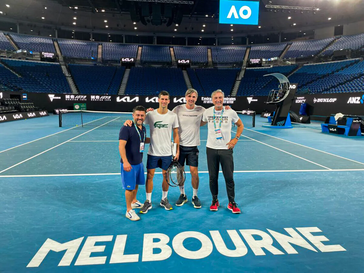 Serbian tennis player Novak Djokovic (2nd L) and his team on Rod Laver Arena Court at the Australian Open in Melbourne, Australia, in a photo uploaded to Twitter on Jan. 11, 2022. (Courtesy of DjokerNole/Twitter via Reuters)