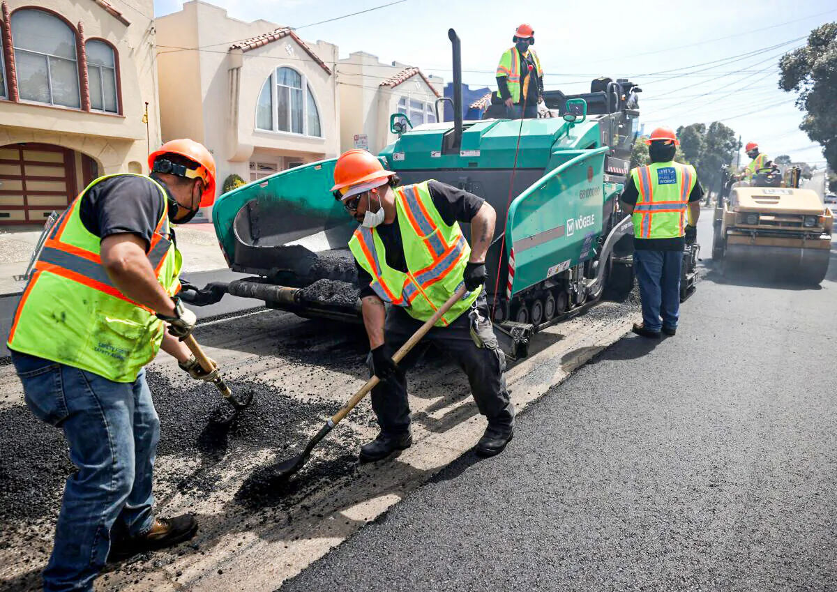 Workers with the San Francisco Department of Public Works repave a section of 24th Ave. on Apr. 8, 2021 in San Francisco, Calif. (Justin Sullivan/Getty Images)
