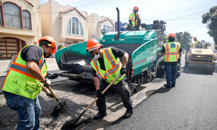 Workers with the San Francisco Department of Public Works repave a section of 24th Ave. on Apr. 8, 2021 in San Francisco, Calif. (Justin Sullivan/Getty Images)