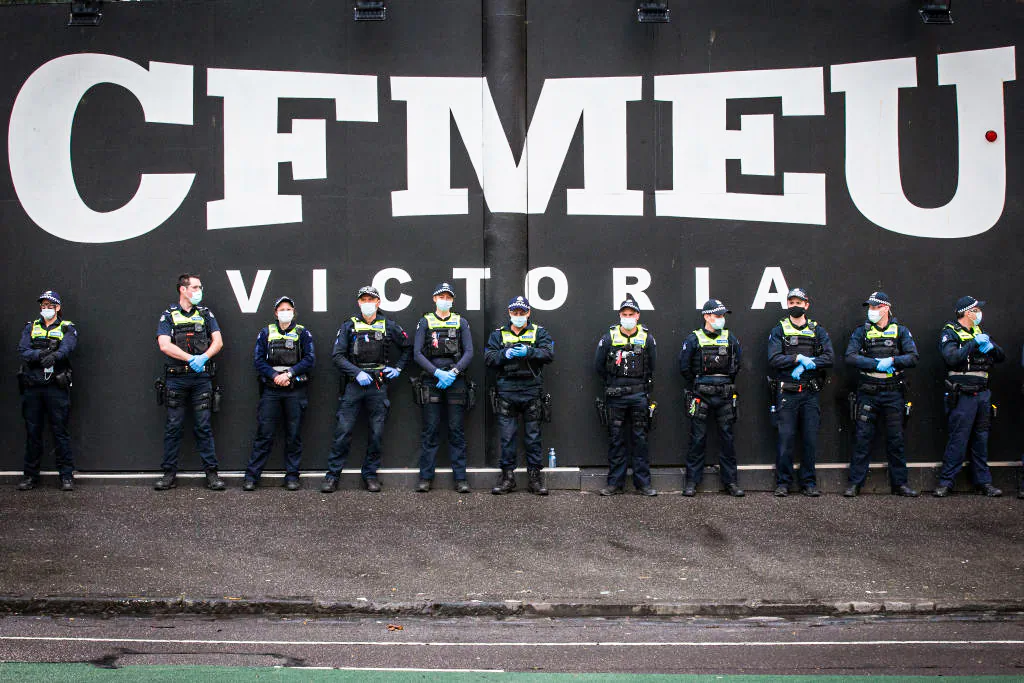 Members of Victoria Police stand outside the CFMEU Office in Melbourne, Australia, on Sept. 21, 2021. (Darrian Traynor/Getty Images)