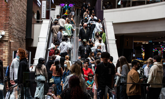 Shoppers ride an escalator at Melbourne Central during the Boxing Day sales in Melbourne, Australia on Dec. 26, 2021. (Diego Fedele/Getty Images)