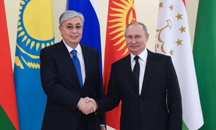 Kazakh President Kassym-Jomart Tokayev greets Russian President Vladimir Putin before the informal annual summit of the Commonwealth of Independent States (CIS) at the presidential residence of Konstantin Palace in Strelna, outside St. Petersburg, Russia, on Dec. 28, 2021. (Yevgeny BiyatovI/AFP via Getty Images)