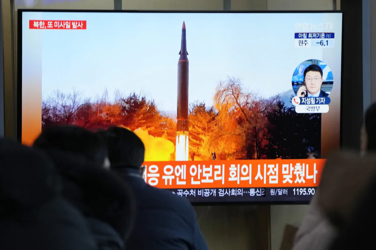 People watch a TV showing a file image of North Korea's missile launch during a news program at the Seoul Railway Station, South Korea, on Jan. 11, 2022. (Ahn Young-joon/AP Photo)