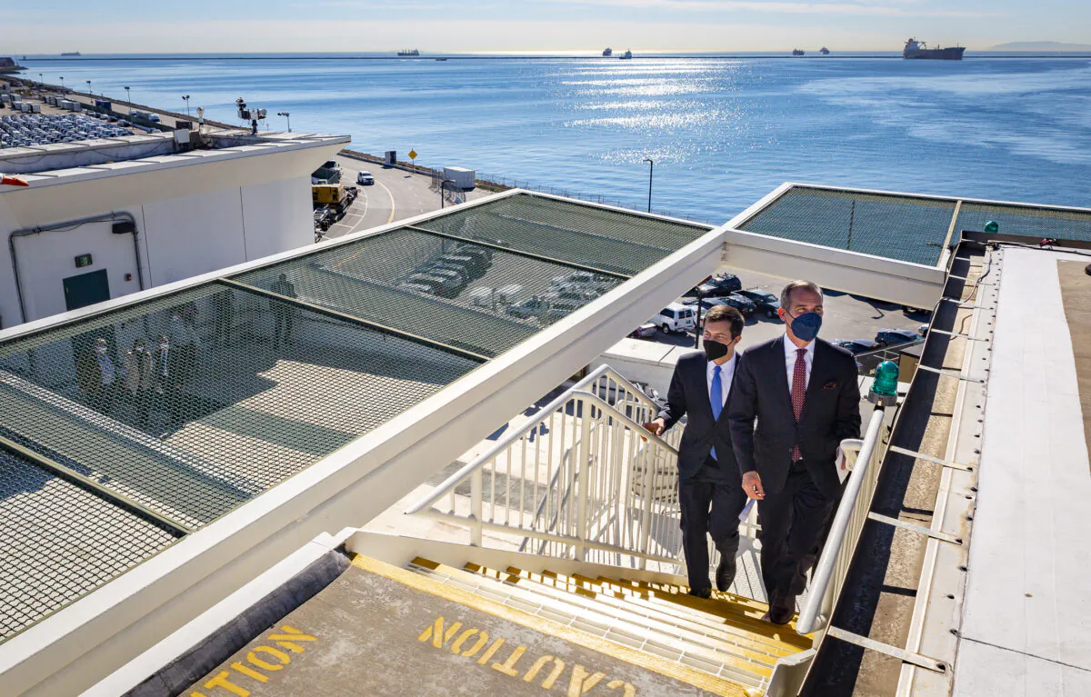 United States Secretary of Transportation Pete Buttigieg and Los Angeles Mayor Eric Garcetti visit the Port of Long Beach, Calif., on Jan 11, 2022. (John Fredricks/The Epoch Times)