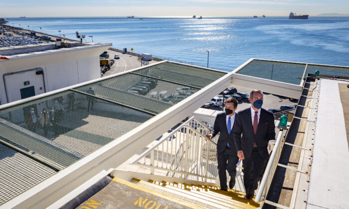 United States Secretary of Transportation Pete Buttigieg and Los Angeles Mayor Eric Garcetti visit the Port of Long Beach, Calif., on Jan 11, 2022. (John Fredricks/The Epoch Times)