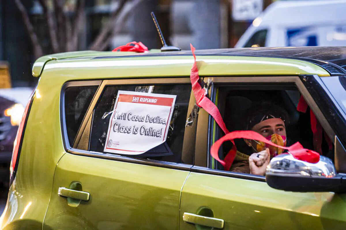 Members of the Chicago Teachers Union and supporters stage a car caravan protest outside City Hall in the Loop in Chicago, Ill., on Jan. 5, 2022. (Ashlee Rezin /Chicago Sun-Times via AP)