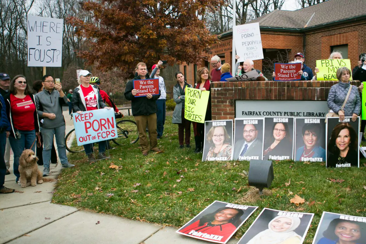 Parents and residents protest against a display featuring the Bible next to "Gender Queer" and "Lawn Boy"—the two challenged books returned to Fairfax County school libraries after the Thanksgiving holiday—outside Dolley Madison Public Library in McLean, Va., on Dec. 11, 2021. (Lisa Fan/The Epoch Times)