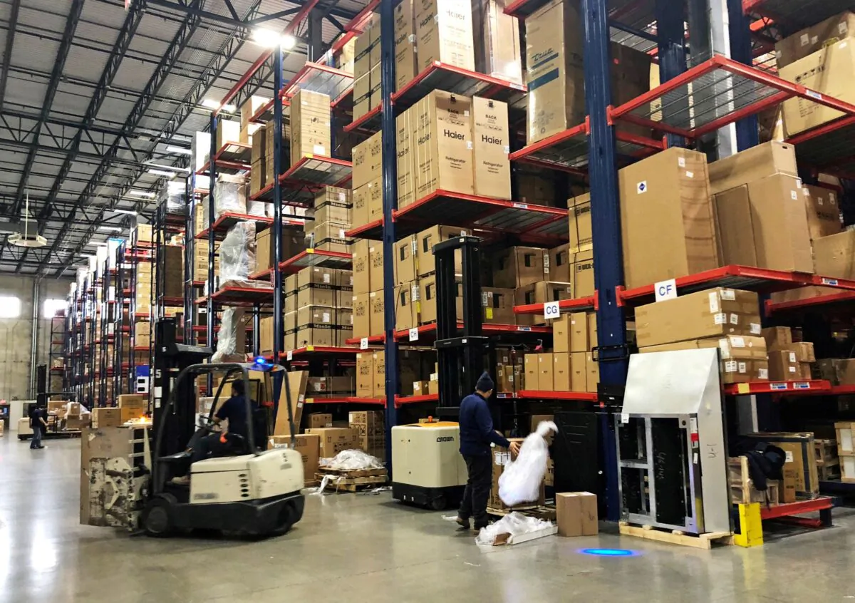 Warehouse workers deal with inventory stacked up to the ceiling at an ABT Electronics Facility in Glenview, Ill., on Dec. 4, 2018. (Richa Naidu/Reuters)