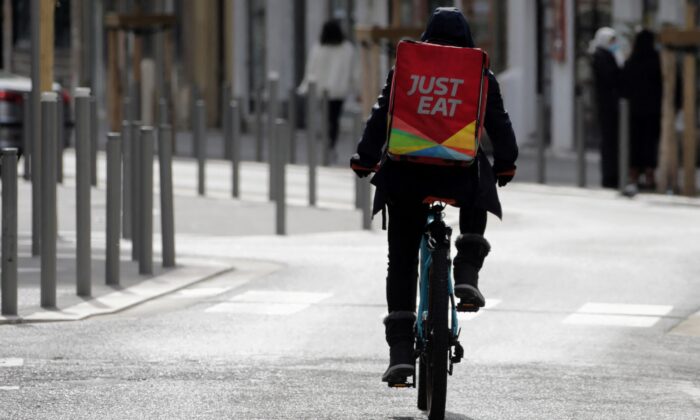 A Just Eat delivery man rides his bicycle in Nice, France on Feb. 16, 2021. (Eric Gaillard/Reuters)