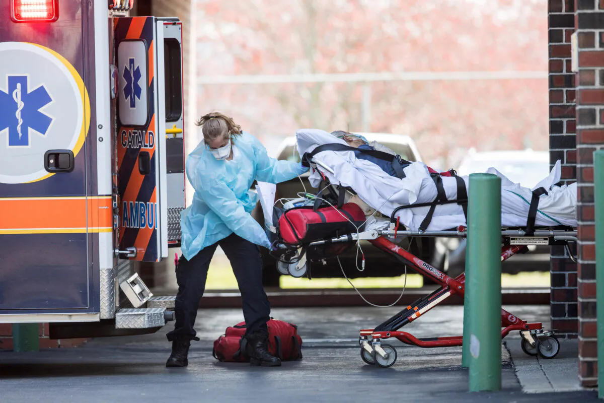 A first responder loads a patient into an ambulance in Chelsea, Mass., on April 17, 2020. (Scott Eisen/Getty Images)