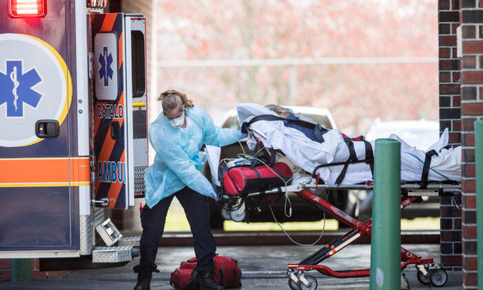 First responders load a patient into an ambulance from a nursing home where multiple people have contracted COID-19 on April 17, 2020 in Chelsea, Massachusetts. (Scott Eisen/Getty Images)