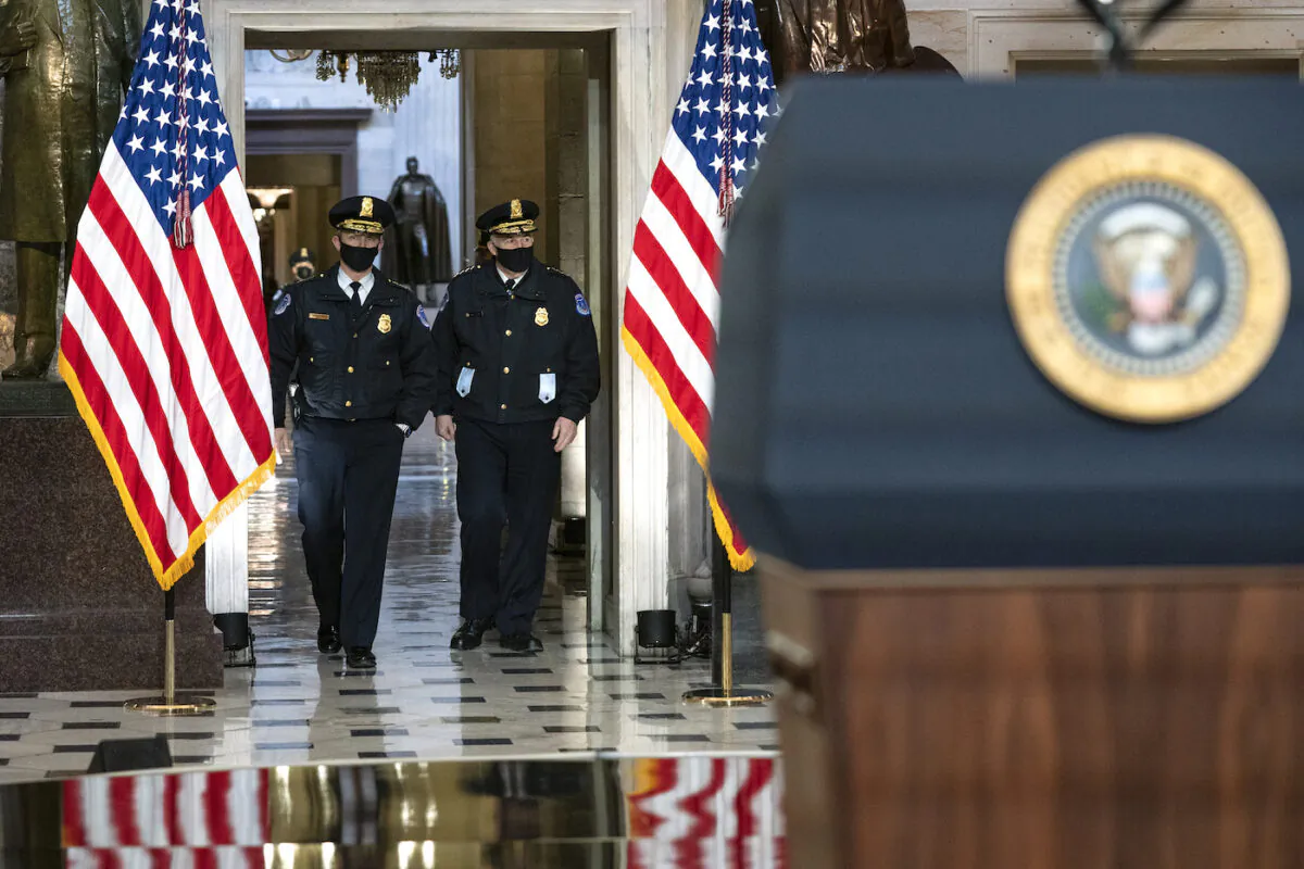 U.S. Capitol Police Chief Tom Manager, right, is seen before U.S. President Joe Biden and Vice President Kamala Harris give remarks in Statuary Hall of the U.S Capitol on Jan. 6, 2022 in Washington, D.C. (Greg Nash-Pool/Getty Images)