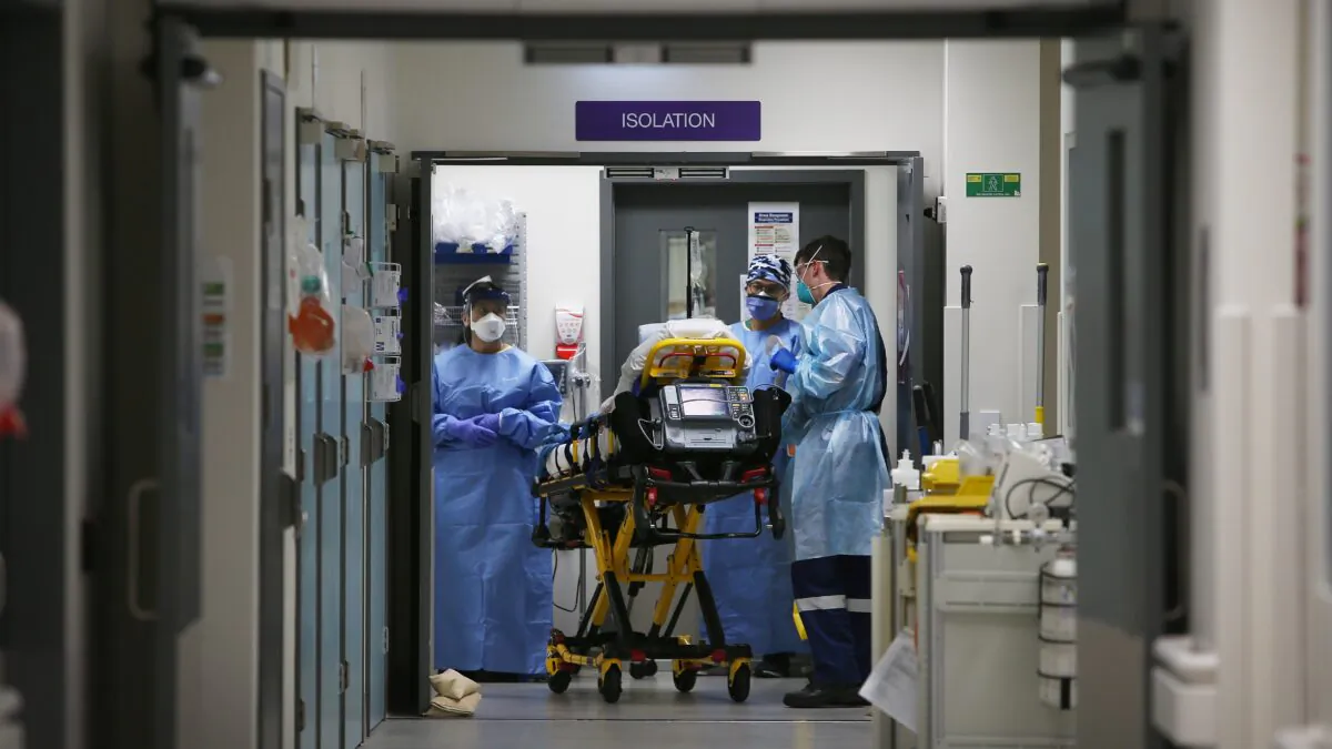 Emergency Medicine Specialist Dr Kevin Maruno and medical team take a suspected COVID-19 patient in to the isolation ward in the Red zone of the Emergency Department at St Vincent's Hospital in Sydney, Australia on Jun. 4, 2020. (Photo by Lisa Maree Williams/Getty Images)