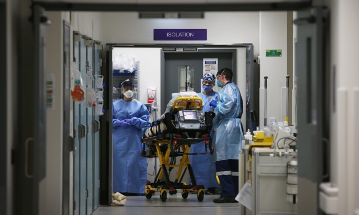 Emergency Medicine Specialist Dr Kevin Maruno and medical team take a suspected COVID-19 patient in to the isolation ward in the Red zone of the Emergency Department at St Vincent's Hospital in Sydney, Australia on Jun. 4, 2020. (Photo by Lisa Maree Williams/Getty Images)