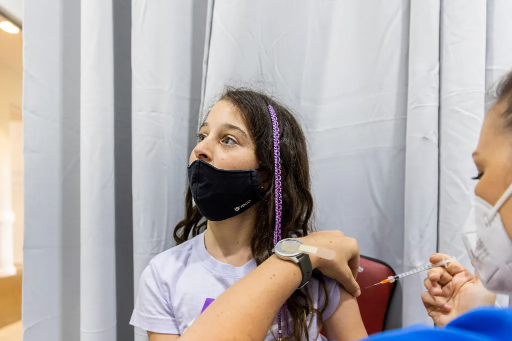 A registered nurse administers the Pfizer COVID-19 vaccine to a young girl at Sydney Road Family Medical Practice in Balgowlah in Sydney, Australia, on Jan. 11, 2022. (Jenny Evans/Getty Images)
