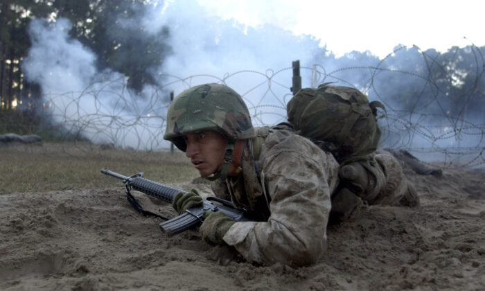 United States Marine Corps recruit Montarez crawls through an event on The Crucible during boot camp on Parris Island, S.C., on Jan. 15, 2003. (Stephen Morton/Getty Images)