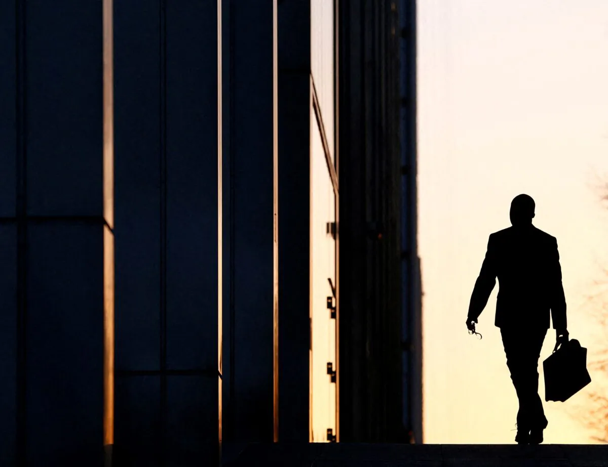 A worker arrives at his office in the Canary Wharf business district in London, on Feb. 26, 2014. (Reuters)

