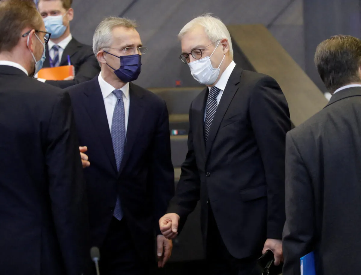 NATO Secretary-General Jens Stoltenberg chats with Russian Deputy Foreign Minister Alexander Grushko ahead of NATO-Russia Council at the Alliance's headquarters in Brussels, Belgium, on Jan. 12, 2022. (Olivier Hoslet/Pool via Reuters)