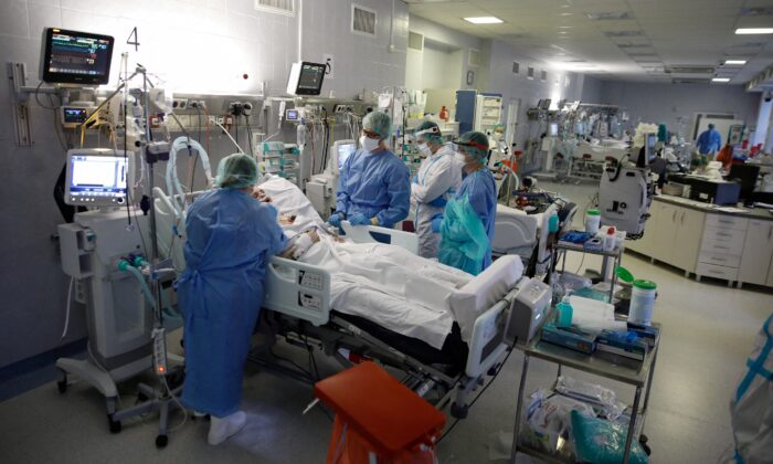 Medical unit   members dainty  patients wrong  the coronavirus illness  (COVID-19) ward astatine  the Central Clinical Hospital of the Ministry of Interior and Administration successful  Warsaw, Poland, connected  Jan. 11, 2022. (Kacper Pempel/Reuters)