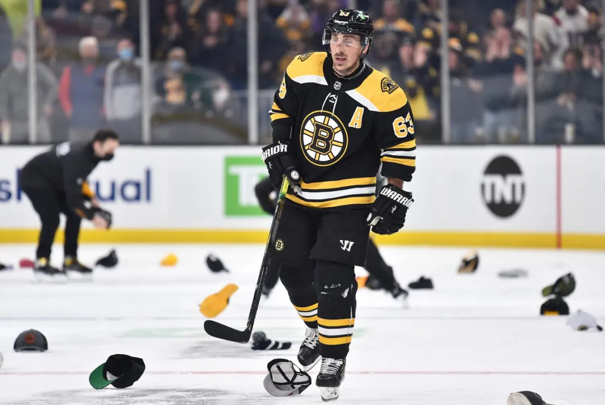 Boston Bruins left wing Brad Marchand (63) skates through a sea of hats, after scoring his third goal of the game during the second period against the Montreal Canadiens at TD Garden, in Boston, on Jan. 12, 2022. (Bob DeChiara/USA TODAY Sports via Field Level Media)