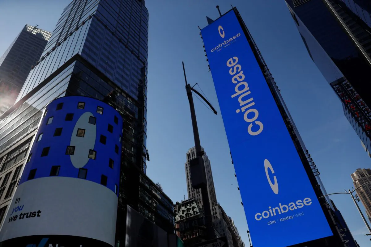 The logo for Coinbase Global Inc., the biggest U.S. cryptocurrency exchange, is displayed on the Nasdaq MarketSite jumbotron and others at Times Square in New York, on April 14, 2021. (Shannon Stapleton/Reuters)