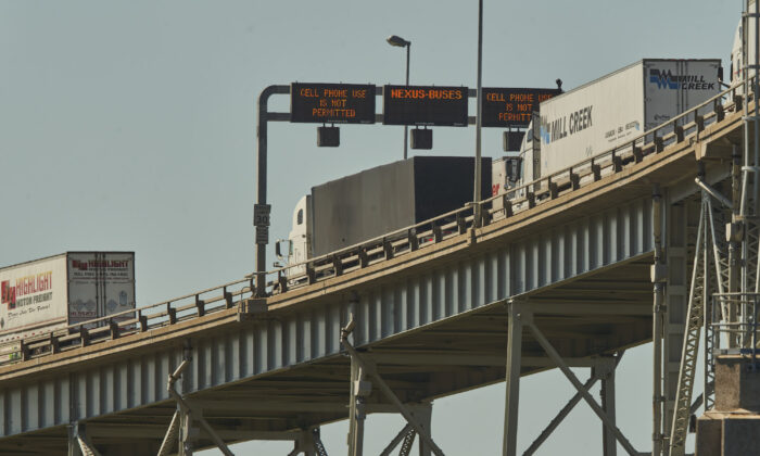 Trucks cross the Bluewater Bridge between Sarnia, Ont., and Port Huron, Mich., on Aug. 15, 2021. (The Canadian Press/ Geoff Robins)