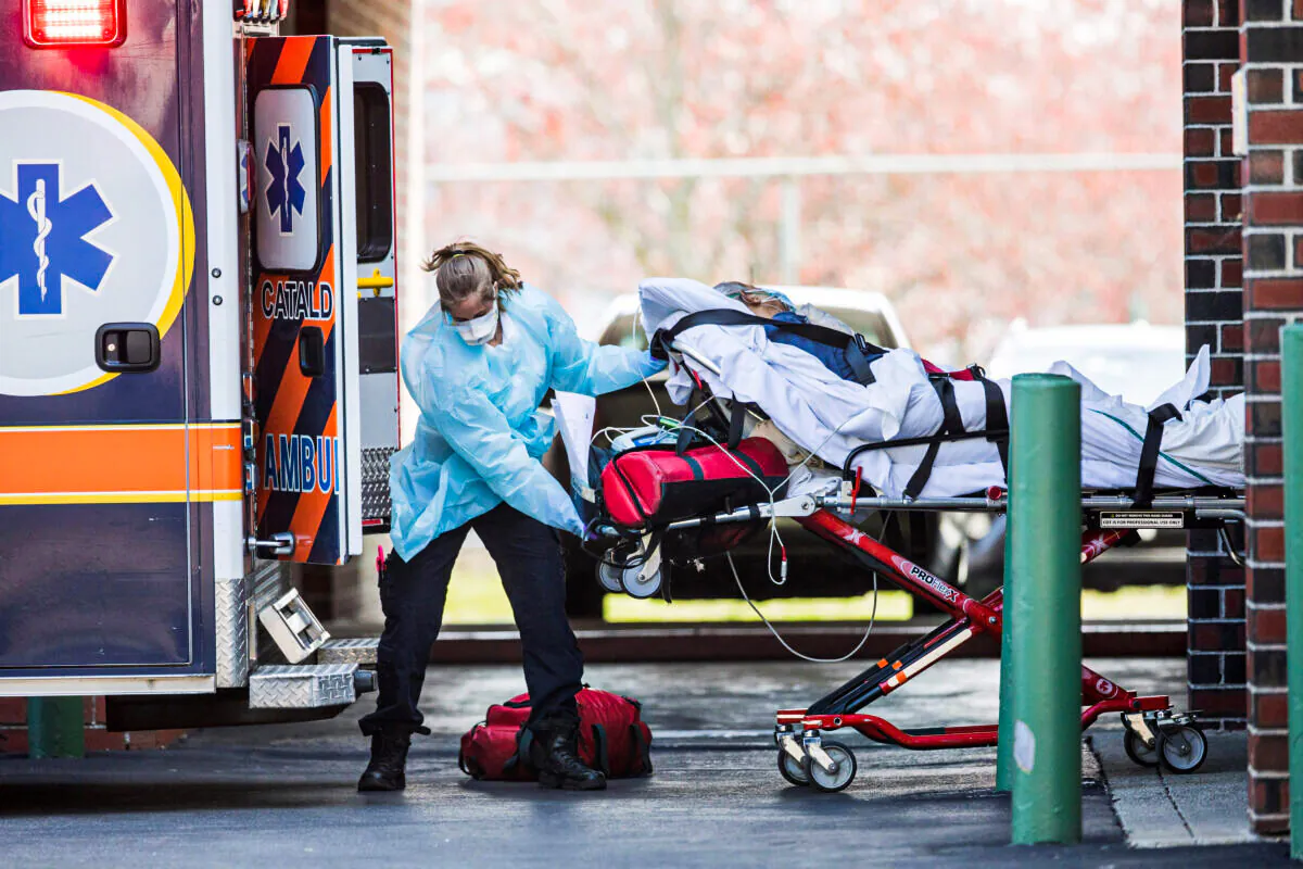 First responders load a patient into an ambulance from a nursing home where multiple people have contracted COVID-19 in Chelsea, Mass., on April 17, 2020. (Scott Eisen/Getty Images)