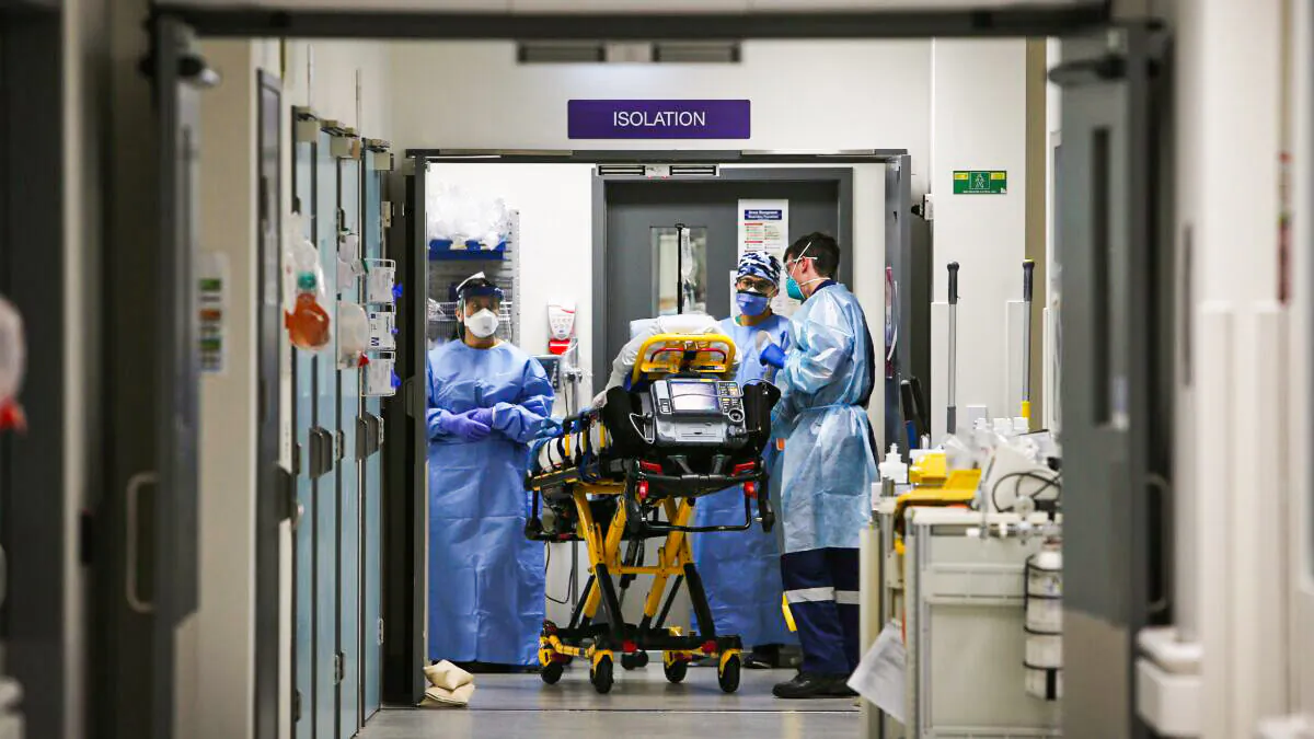 A medical team takes a suspected COVID-19 patient in to the isolation ward in the Red zone of the Emergency Department at St Vincent's Hospital in Sydney, Australia on Jun. 4, 2020. (Photo by Lisa Maree Williams/Getty Images)