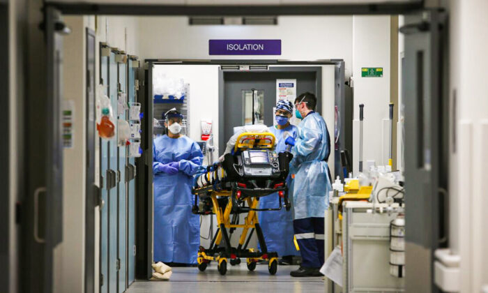 Emergency Medicine Specialist Dr Kevin Maruno and medical team take a suspected COVID-19 patient in to the isolation ward in the Red zone of the Emergency Department at St Vincent's Hospital in Sydney, Australia on Jun. 4, 2020. (Photo by Lisa Maree Williams/Getty Images)