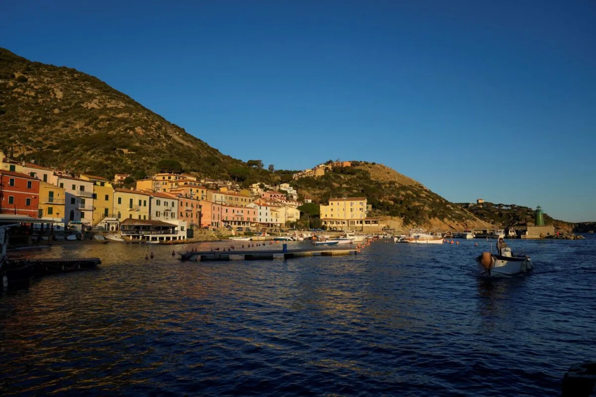 A fishing boat enters the port of the tiny Tuscan island of Isola del Giglio, Italy, on Jan. 13, 2022. (Andrew Medichini/AP Photo)