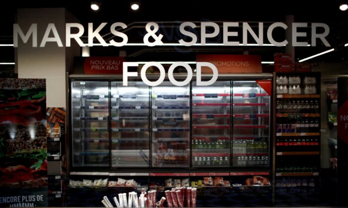 Empty shelves are seen behind a M&S logo at a Marks & Spencer food store in Paris, on Jan. 5, 2021. (Gonzalo Fuentes/Reuters)