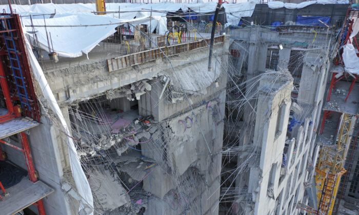 The exterior wall of an apartment under construction is seen collapsed at a site in Gwangju, South Korea, on Jan. 12, 2022. (Jung Hee-sung/Yonhap via AP)