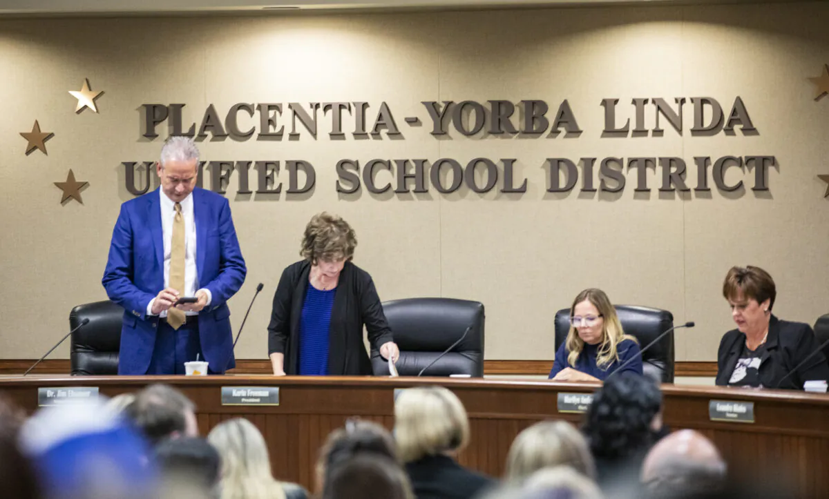 Placentia Yorba Linda Unified School District board members prepare for a public meeting with parents gathered in mass to express their concerns for mandatory vaccine mandates for their children in Placentia, Calif., on Oct. 12, 2021. (John Fredricks/The Epoch Times)
