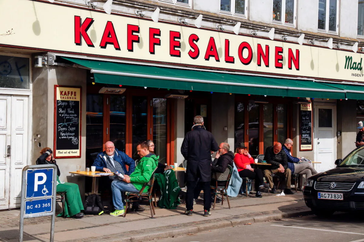 People sit at Kaffesalonen (The Coffee Saloon) as COVID-19 restrictions ease, in central Copenhagen, Denmark, in a file photo. (Tim Barsoe/Reuters)
