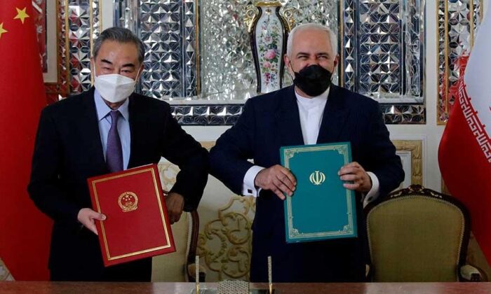 Iranian Foreign Minister Mohammad Javad Zarif (R) and his Chinese counterpart Wang Yi, pose for a picture after signing an agreement in Tehran, Iran on March 27, 2021. (AFP via Getty Images)