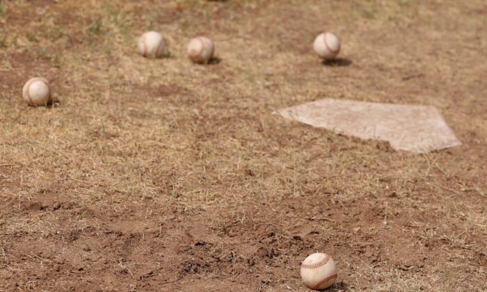 Baseballs are seen on the backyard dirt of the MLB season around a home plate in Scottsdale, Ariz., on June 5, 2020. (Christian Petersen/Getty Images)