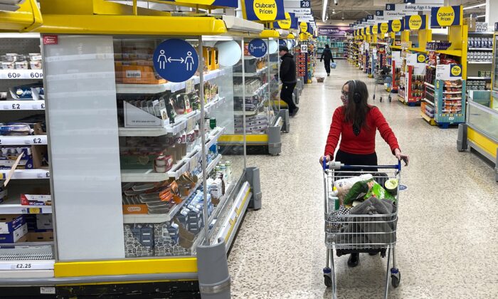 A customer shops for food items inside a Tesco supermarket store in east London, on Jan. 10, 2022. (Daniel Leal/AFP via Getty Images)
