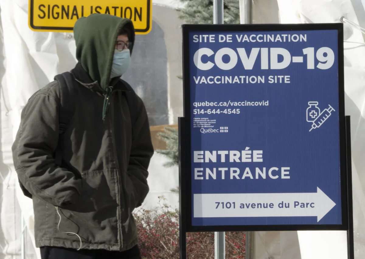 A man enters a COVID-19 vaccination site in Montreal on Dec. 1, 2021. (Ryan Remiorz/The Canadian Press)