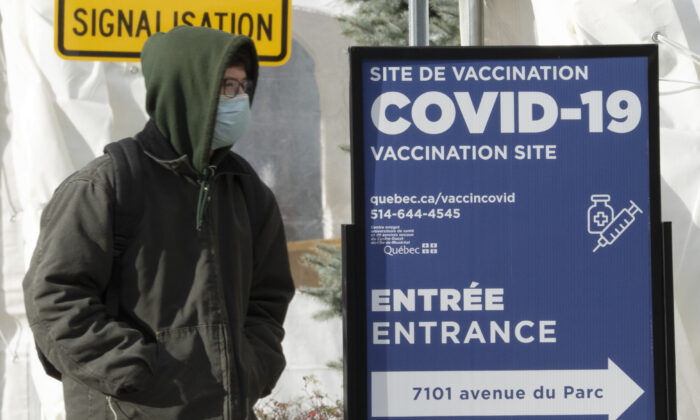 A man enters a COVID-19 vaccination site in Montreal on Dec. 1, 2021. (Ryan Remiorz/The Canadian Press)